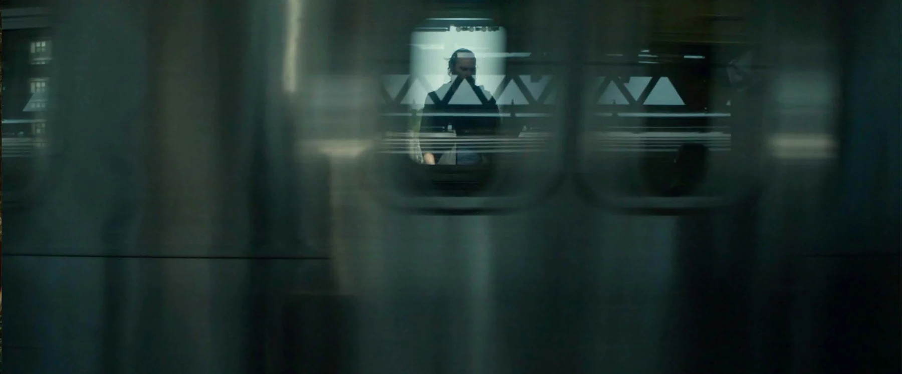 A figure is fragmented by overlapping reflections.